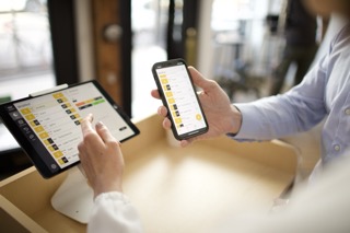 Restaurant team using Carbonara on phone and tablet